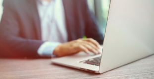 Man using laptop to research filing bankruptcy for a second time 